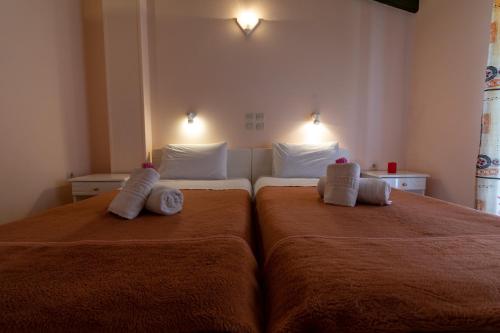 a bedroom with two beds with towels on them at Andreas House in Dassia