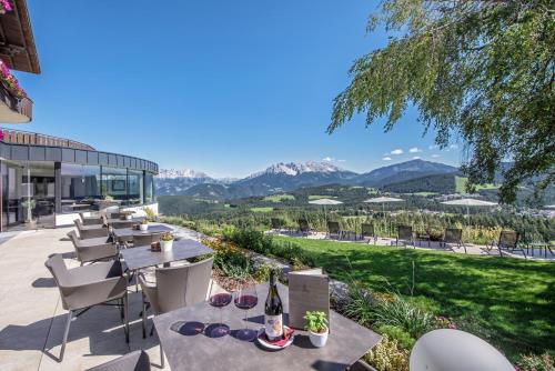 a patio with a view of the mountains at Panoramahotel Obkircher in Nova Ponente