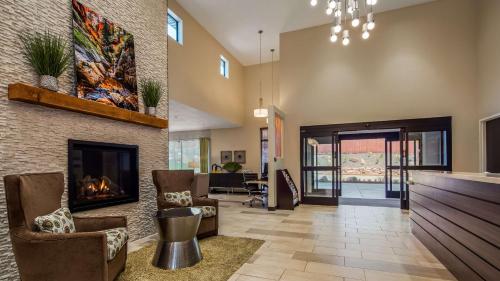 a living room with a fireplace and a lobby at Best Western Plus Zion Canyon Inn & Suites in Springdale