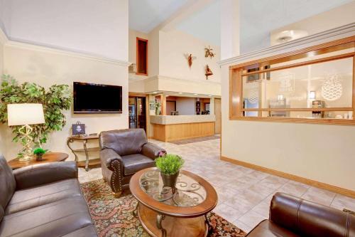 a living room with a couch and a table at Super 8 by Wyndham Aberdeen East in Aberdeen