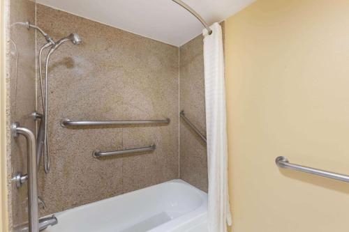 a shower stall in a bathroom with a tub at Super 8 by Wyndham Jacksonville AR in Jacksonville