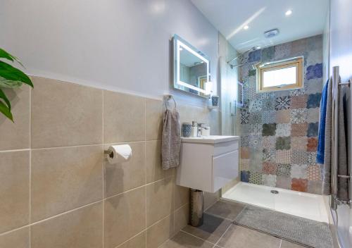 a bathroom with a shower and a toilet and a sink at Stones Throw Studio Apartment Bude Cornwall in Bude