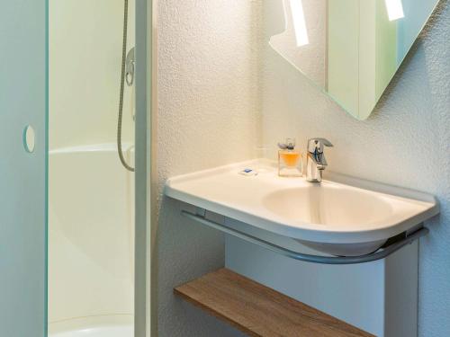 a bathroom with a sink and a shower at ibis budget Paris Porte d'Italie Ouest in Le Kremlin-Bicêtre