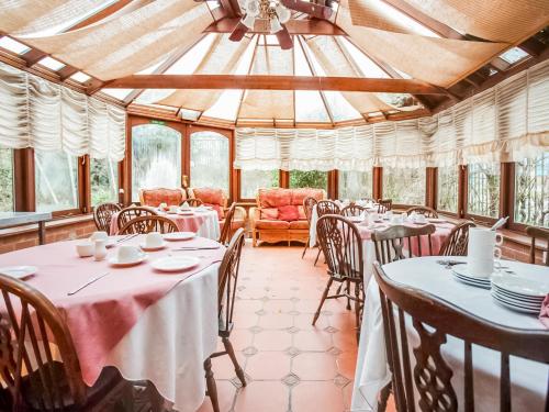 a dining room with tables and chairs and windows at OYO The Rowers Hotel, Dunston Gateshead in Newcastle upon Tyne