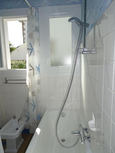 une salle de bain avec une douche, une baignoire et un lavabo dans l'établissement APPARTEMENT SPACIEUX à 60 M DE LA PLAGE location à la semaine du samedi au samedi, à Carnac