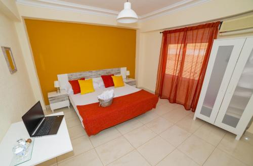 a bedroom with a bed and a laptop on a desk at Old Town Alicante in Alicante