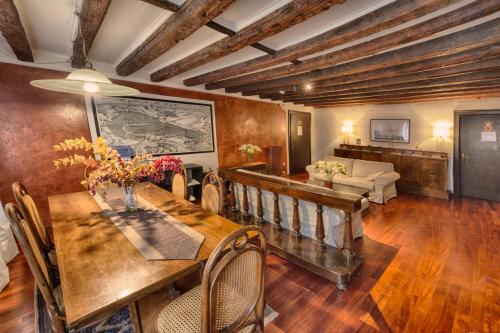 a dining room with a table and a couch at San Giacomo Venezia in Venice