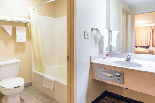 a bathroom with a sink and a toilet and a shower at Econo Lodge Laurel in Laurel