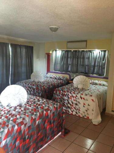Cama ou camas em um quarto em Hotel del Angel