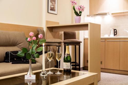 a living room with wine bottles and glasses on a table at Sofia Palace Hotel by HMG in Sofia