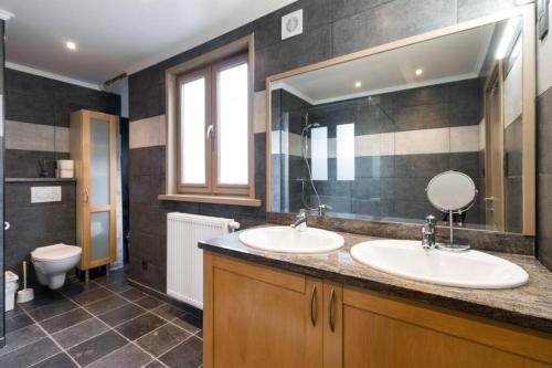 a bathroom with two sinks and a toilet at Spacious Appartment aan damse vaart @ brugge in Bruges