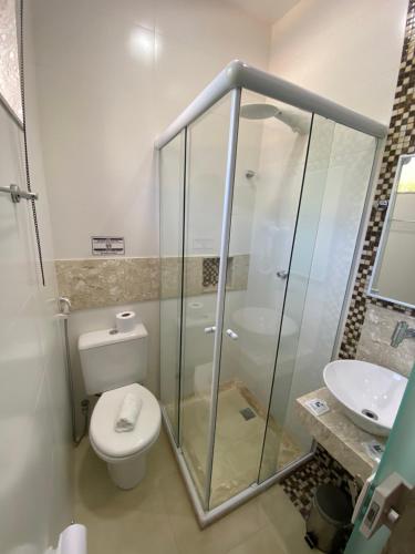 a bathroom with a shower and a toilet and a sink at Palace Hotel in Angra dos Reis