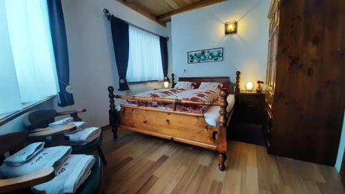 a bedroom with a bed and a wooden floor at Hochkönig Top 6 in Mühlbach am Hochkönig