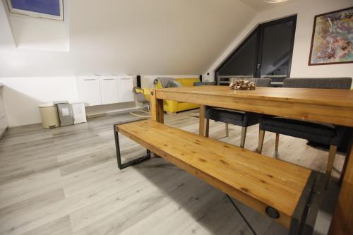 a dining room with a table and benches in a room at Apartmán Peklo in Vrchlabí