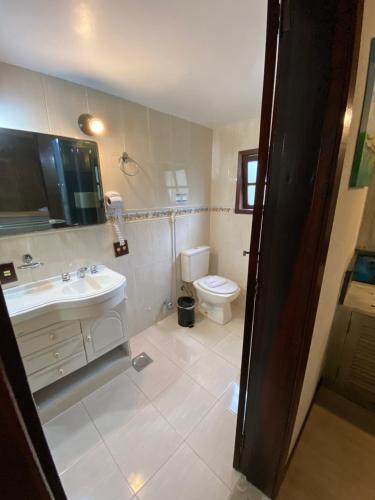 a bathroom with a sink and a toilet at Palace Hotel in Angra dos Reis