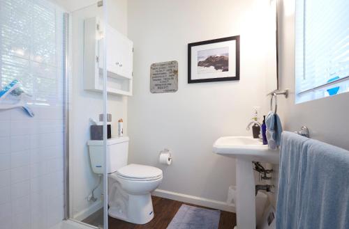 a white bathroom with a toilet and a sink at Willow Glen Private Studio in San Jose