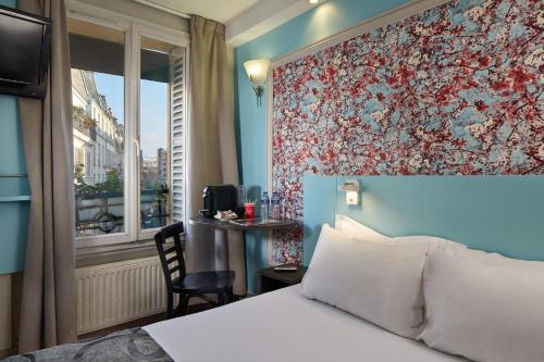 a hotel room with a bed and a window at Garden Saint Martin in Paris