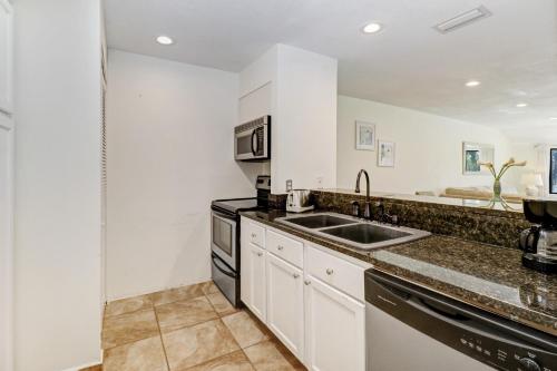 a kitchen with a sink and a stove at Saddlebrook Golf Course view Condo with Kitchen in Wesley Chapel