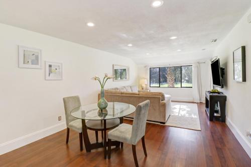 a living room with a table and chairs and a couch at Saddlebrook Golf Course view Condo with Kitchen in Wesley Chapel