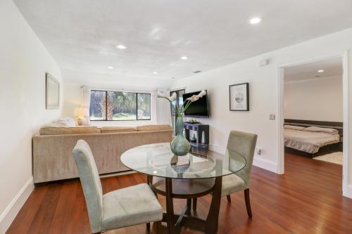 a living room with a glass table and a couch at Saddlebrook Golf Course view Condo with Kitchen in Wesley Chapel