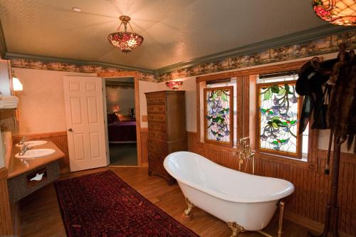 bagno con vasca, lavandino e finestra di Beaver Valley Lodge a Leavenworth