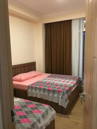 Postel nebo postele na pokoji v ubytování Kvariati apartamenrs