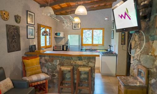 a kitchen with a counter and a stove top oven at Magenta Complejo Cabañas & Spa in San Javier