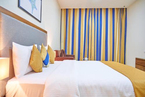 a hotel room with two beds and a large window at City Stay Grand Hotel Apartments - Al Barsha in Dubai
