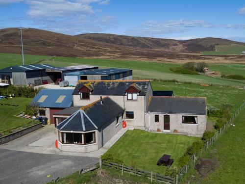 an aerial view of a house in a field at Bachylis Self Catering in Kirkwall