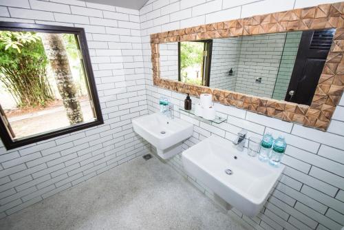 a white bathroom with a sink and a mirror at villa inspiration in Ko Chang