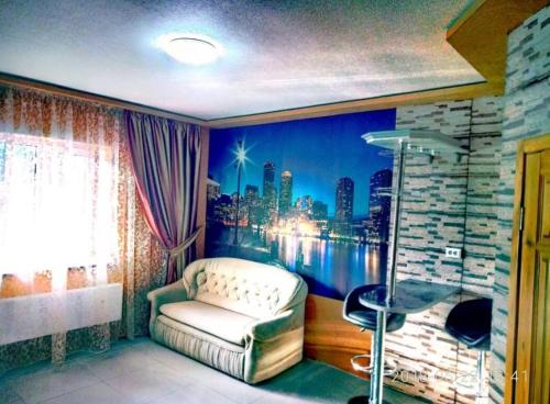 a room with a couch and a view of a city at Апартаменты Голубая Лагуна in Kharkiv