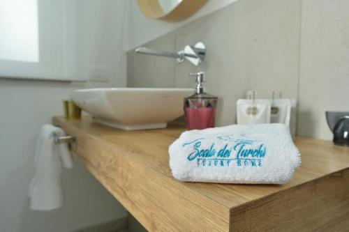 a bathroom counter with a sink and a towel at Scala dei Turchi Luxury Home in Realmonte
