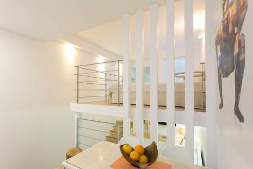 a white staircase with a bowl of fruit on a table at Soul of Lisbon - II in Lisbon