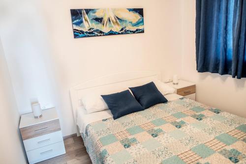 a bedroom with a bed and a painting on the wall at Bilić S in Dugi Rat