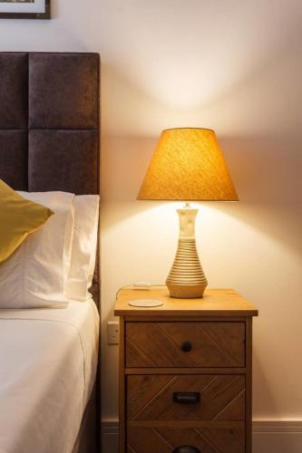 a lamp on a night stand next to a bed at Stay@Coast in Bournemouth