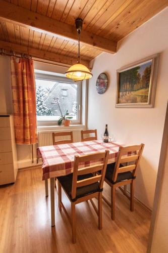 a dining room with a table and chairs and a window at Penzion u Vichu in Červená Voda