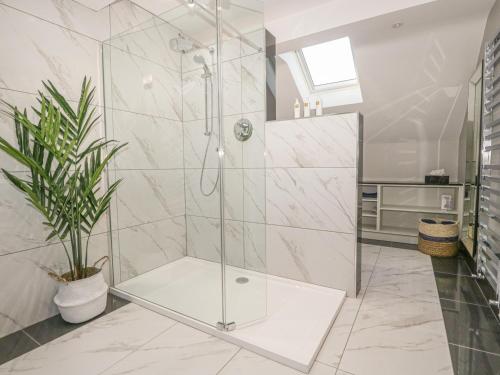a bathroom with a shower with a glass door at Bishop Fell in Newby Bridge