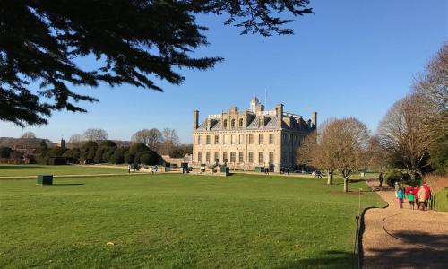 a large building in a park with people walking around it at Stay@Coast in Bournemouth