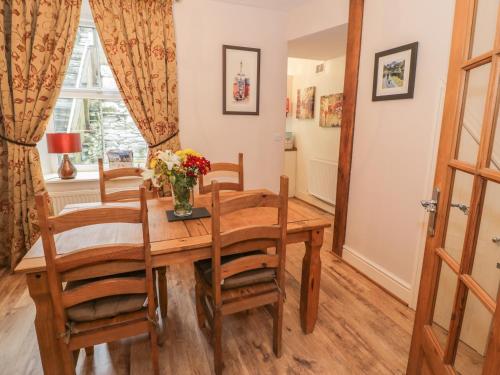 a dining room with a wooden table and chairs at Manod View in Blaenau-Ffestiniog