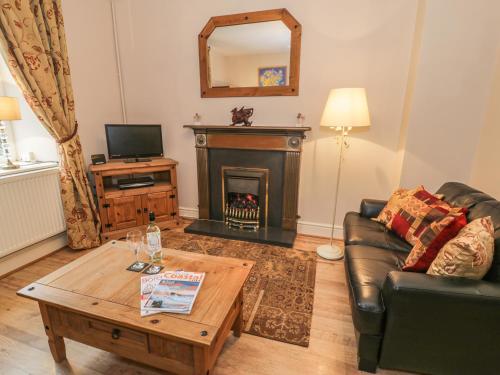 a living room with a couch and a fireplace at Manod View in Blaenau-Ffestiniog