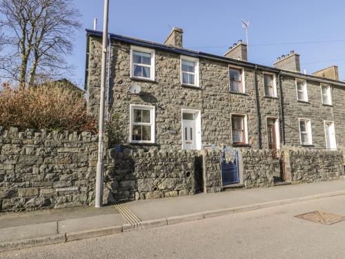 an old stone house on the side of a street at Manod View in Blaenau-Ffestiniog