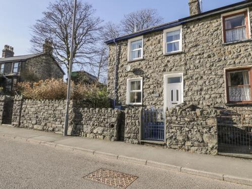 a stone house with a stone retaining wall at Manod View in Blaenau-Ffestiniog