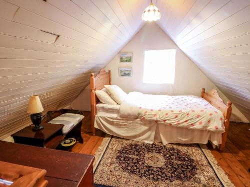 a bedroom with a bed in a attic at Mary Rose Cottage in Castleisland