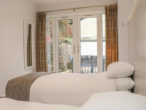 une chambre avec un lit et une fenêtre dans l'établissement The Old Workshop, à Dulverton