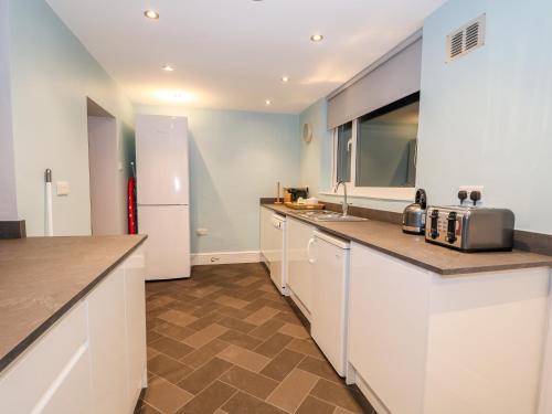 a kitchen with white cabinets and a counter top at Lincoln House in Lincoln