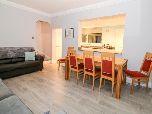 a kitchen and living room with a table and chairs at Lincoln House in Lincoln