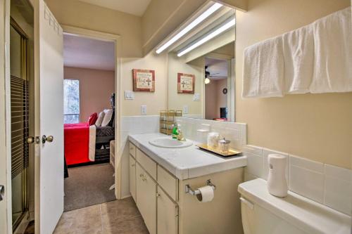 a white bathroom with a sink and a mirror at Houston Apt with Private Balcony 14 Mi to Downtown! in Houston