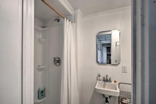 a white bathroom with a sink and a mirror at Cozy Stockbridge Cabin - Walk to Beach and Lake! in Stockbridge