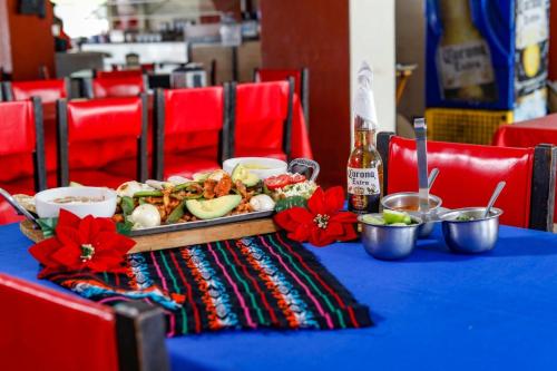 a blue table with a plate of food on it at Hotel Hacienda María Eugenia Acapulco in Acapulco
