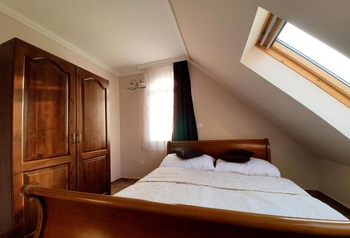 a bedroom with a bed with two pillows on it at Berezdtető Vendégház in Cserépfalu
